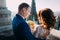 Close-up of newlywed bride and groom hugging on the antique gothic cathedral balcony