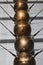 Close-up of a Newton`s cradle made up of a row of large copper balls