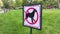 Close-up of no dog sign. Street pointer on a background of green grass. Ban on defecation and running of pets on park lawns and