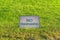 Close up of No Trespassing sign against terrain covered with vibrant grasses