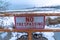 Close up of No Trespassing signage with snowy Utah Lake background in winter