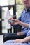 Close up of nurse taking old patient insulin level test using glucometer during consultation