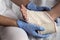 Close-up Of A Nurse Tying Bandage On Patient`s Foot