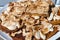 Close-up of oblong pieces of home-made crumble cake with strawberry jam covered with meringue served on wooden table.