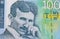 Close up of Obverse of 100 dinars paper bill issued by Serbia, that shows portrait of scientist Nikola Tesla