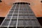 Close-up of old acoustic guitar fretboard with selective focus