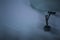 Close-up of old airplane departure over background of rainy sky.