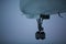 Close-up of old airplane departure over background of rainy sky.