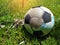 Close up old ball tear on lawn,equipment for soccer sport