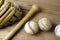 Close up old baseball, wooden baseball bat and baseball glove on a woodeb table. select focus.