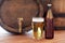 Close up of old beer barrel, glass and bottle