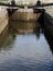 a close up of old closed wooden lock gates on the calder and hebble navigation canal in brighouse reflected in the water