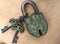Close-up of an old corroded padlock with two keys and with an elephant pattern, probably of indian origin