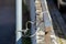 Close up of old damaged bicycle lock tied between a metal railing and a signpost