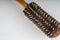 Close up of old dirty hairbrush. Comb with different hair on white background.