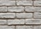Close up of an old distressed white brick wall, used for interiors