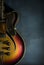 Close-up of old electric jazz guitar on a dark blue background