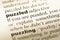 Close up of old English dictionary page with word puzzled