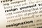 Close up of old English dictionary page with word resign yourself