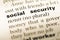 Close up of old English dictionary page with word social security