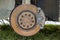 Close-up of old forsaken abandoned rusty broken trash car brake disc detail without rubber tire outdoors in field