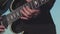 Close-up of old hands of guitarist playing bass guitar. Stock. Masterful performance of playing guitar of old musician