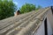 Close up on old house asbestos roof with brick chimney