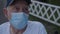 Close up old man in medical mask speaks to doctor