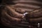 Close up of an old man`s hands folding a piece of paper