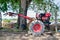 Close up of the old red tiller tractor or walking tractor parked under the tree in the fields at countryside, Thailand