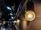 Close up of old round light bulbs beside the concrete wall at night in Bangkok, Thailand on blurred bokek background. Light from a