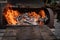 Close up of old rusty barbecue grill with burning wood and grill grates