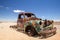 Close up of an old, rusty car wreck in the Namibian desert
