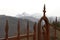 Close-up, an old rusty gate on the walls of the fortress of Mont`Alfonso with the snow-capped Apuan Alps in the background, in Cas