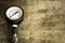 Close up old and rusty pressure gauge on wood background,vintage style.