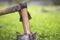 Close-up of old sharp dirty weathered iron ax cutting through chunk of firewood.