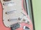 close up of an old style pink electric guitar. Details of rock guitar.