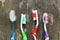 Close up of old toothbrushes on wooden background.