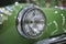 Close up old vintage green car headlight chrome