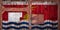 Close-up of old warehouse gate with national flag