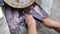 Close up of and old woman`s hands cleaning and slicing fish on an a wooden board