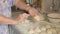 Close-up, old woman stuffing dough for patties with cottage cheese