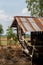 Close-up of old wooden cabin with zinc roof.