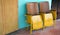 Close up of old wooden folding cinema chair or folding seat in front of Asian theater.