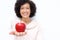 Close up older woman holding red apple in hand