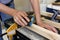 Close up of older woman sanding timber 4