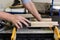 Close up of older woman sanding timber