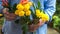 Close-up of older womans hands holding a bouquet of flowers