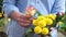 Close-up of older womans hands holding a bouquet of flowers