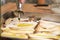 Close-up of olive oil being poured over sliced raw king trumpet mushrooms pleurotus eryngii